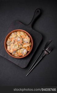 Delicious boiled beef or pork tongue sliced with carrots, onions, sour cream and spices in a ceramic plate