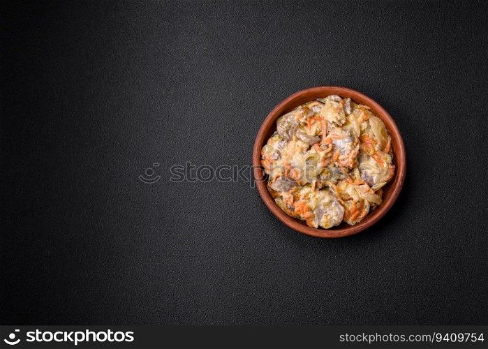 Delicious boiled beef or pork tongue sliced with carrots, onions, sour cream and spices in a ceramic plate