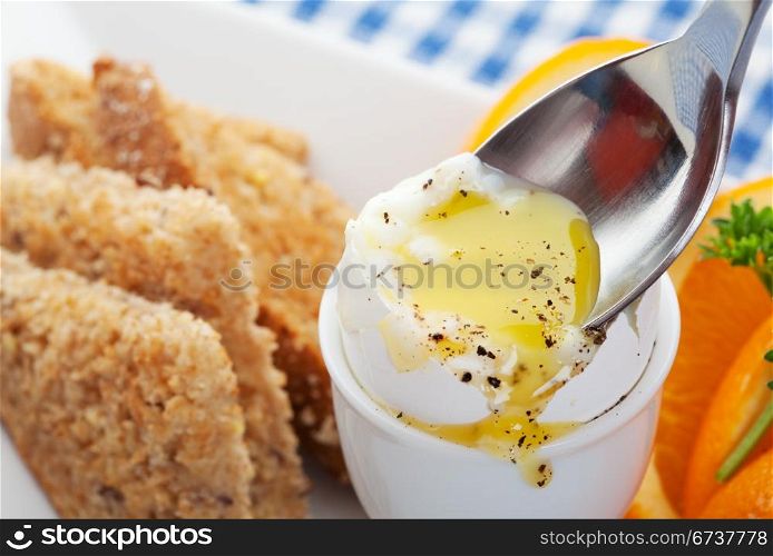 Delicious boiled egg with toast oranges and parsleyfor breakfast