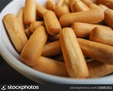 Delicious bread sticks in white bowl