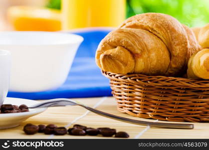 Delicious breakfast. Croissants and cup of coffee on breakfast table