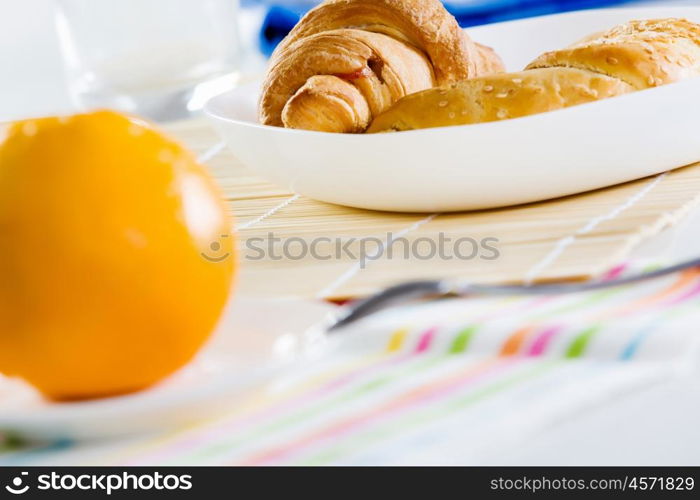 Delicious breakfast. Croissants and cup of coffee on breakfast table