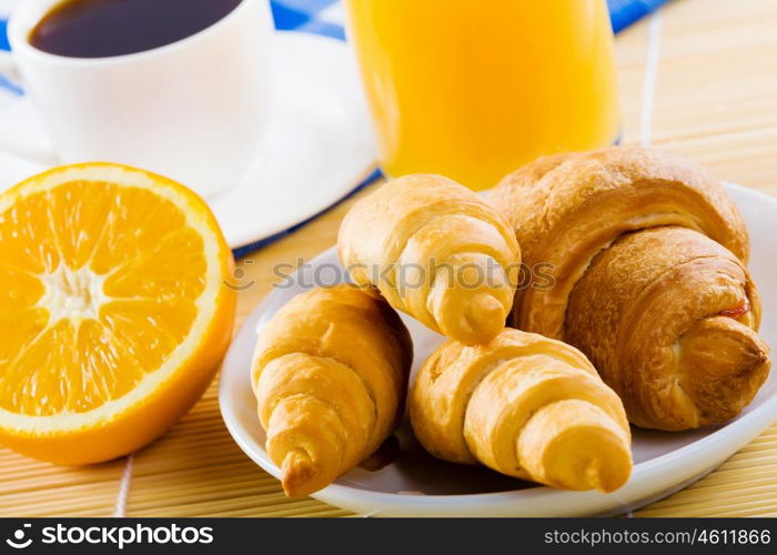 Delicious breakfast. Croissants and cup of coffee on breakfast table