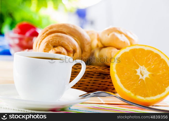 Delicious breakfast. Croissants and cup of coffee on breakfast table