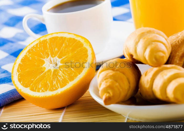 Delicious breakfast. Croissants and cup of coffee on breakfast table