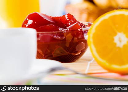 Delicious breakfast. Croissants jelly and cup of coffee on breakfast table