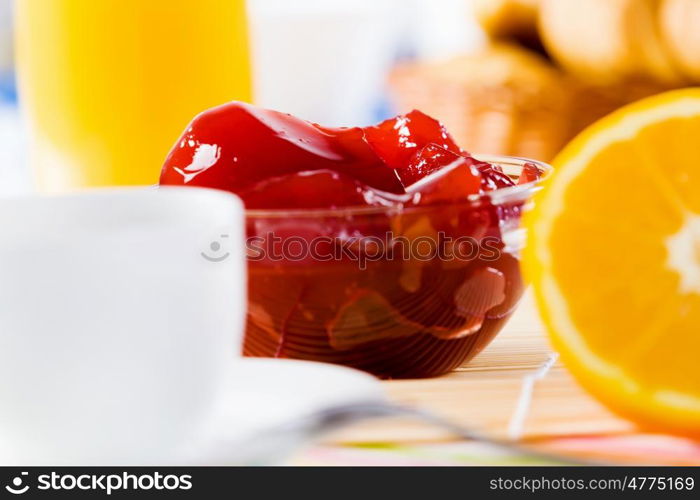 Delicious breakfast. Croissants jelly and cup of coffee on breakfast table