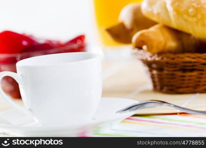 Delicious breakfast. Croissants jelly and cup of coffee on breakfast table