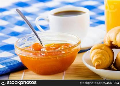 Delicious breakfast. Croissants jelly and cup of coffee on breakfast table