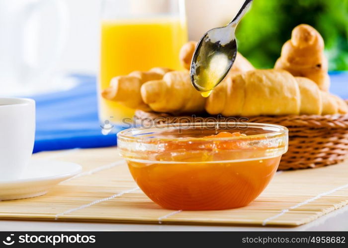 Delicious breakfast. Croissants jelly and cup of coffee on breakfast table