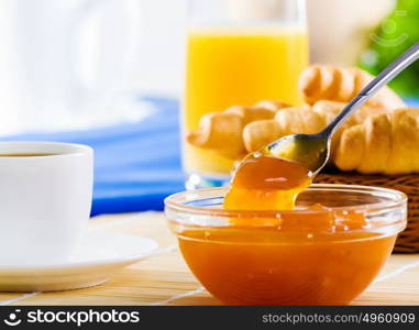 Delicious breakfast. Croissants jelly and cup of coffee on breakfast table