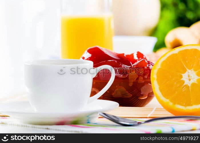 Delicious breakfast. Croissants jelly and cup of coffee on breakfast table