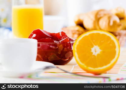 Delicious breakfast. Croissants jelly and cup of coffee on breakfast table