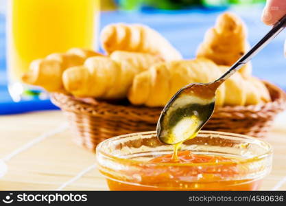 Delicious breakfast. Croissants jelly and orange juice on breakfast table