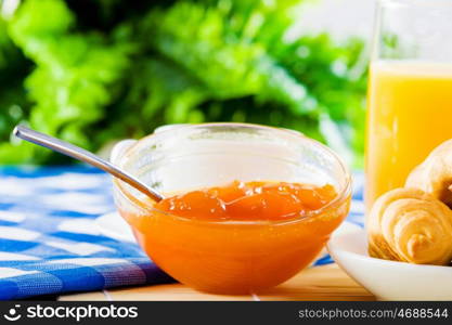 Delicious breakfast. Croissants jelly and orange juice on breakfast table