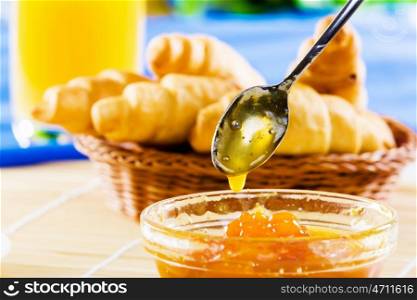 Delicious breakfast. Croissants jelly and orange juice on breakfast table