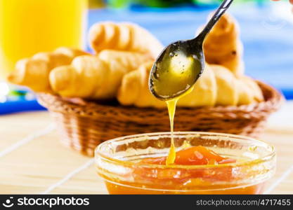 Delicious breakfast. Croissants jelly and orange juice on breakfast table