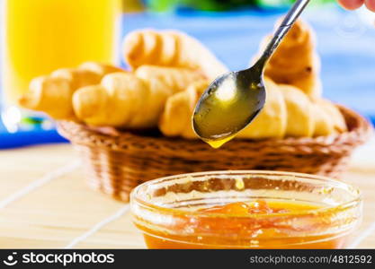 Delicious breakfast. Croissants jelly and orange juice on breakfast table