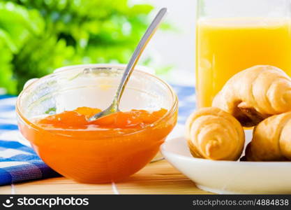 Delicious breakfast. Croissants jelly and orange juice on breakfast table