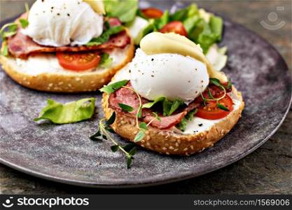 Delicious breakfast with eggs Benedict and salad. Eggs Benedict with salad on the plate