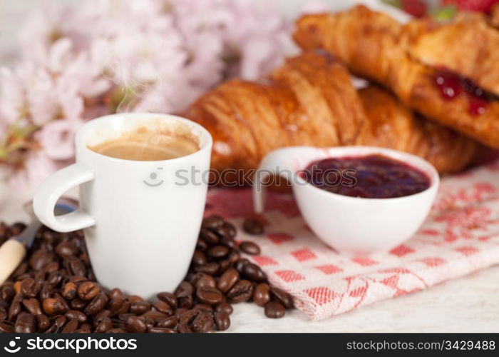 Delicious breakfast with hot coffee and croissant