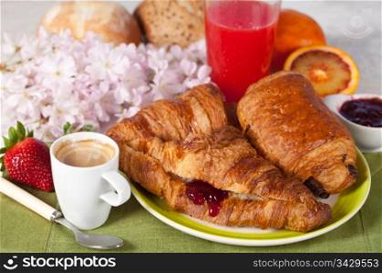 Delicious breakfast with hot coffee and croissant