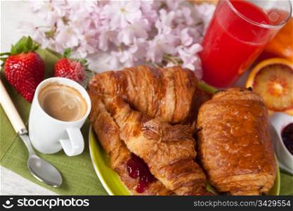 Delicious breakfast with hot coffee and croissant