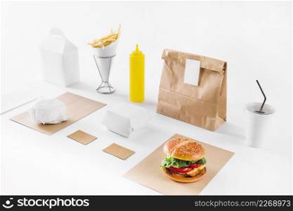 delicious burger parcels disposal cup sauce bottle white background