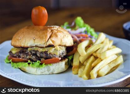 Delicious burger with beef, tomato, cheese and lettuce.