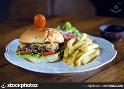 Delicious burger with beef, tomato, cheese and lettuce.