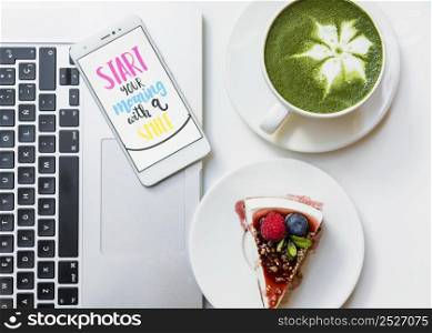 delicious cake slice matcha tea cup mobile phone with message laptop table