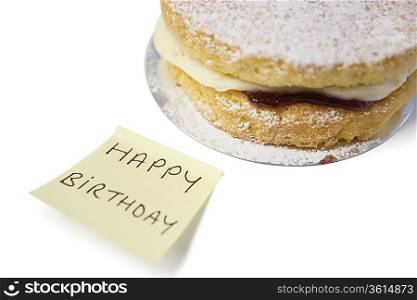 Delicious cake slice with &acute;happy birthday&acute; notepaper