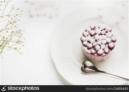 delicious cake with heart shape spoon white plate against white backdrop