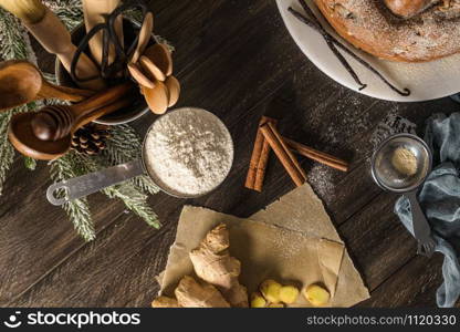 Delicious cake with pear, ginger and cinnamon on a dark kitchen counter.