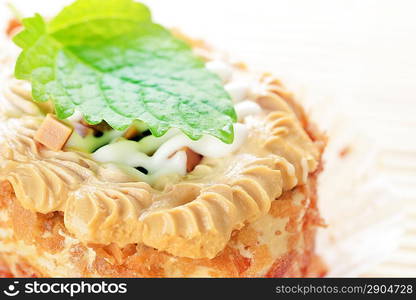 Delicious caramel&acute;s cupcake with white icing on bamboo table cloth