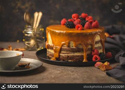 Delicious caramel cake with blackberries and raspberries.