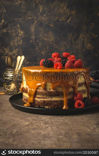 Delicious caramel cake with blackberries and raspberries.