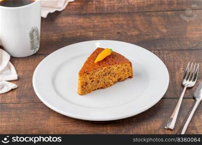 Delicious carrot cake with coffee next to it on wooden table