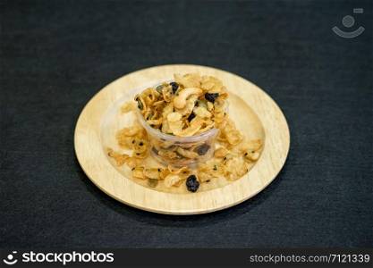 Delicious cereal caramel cornflakes on wooden dish