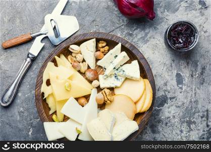 Delicious cheese on the table.Different kinds of cheeses. Set of sliced cheeses