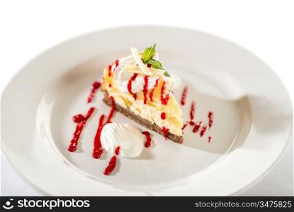 Delicious cheesecake with raspberry sauce on white plate and isolated