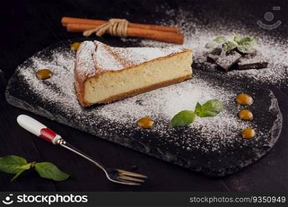 Delicious cheesecake with vanilla on black board