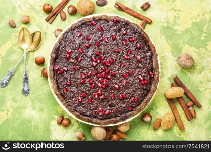 Delicious chocolate cake with pomegranate and nut.Chocolate brownie cake. Chocolate cake with pomegranate