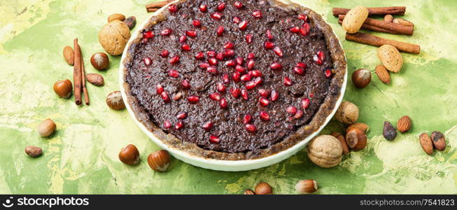 Delicious chocolate cake with pomegranate and nut.Chocolate brownie cake. Chocolate cake with pomegranate