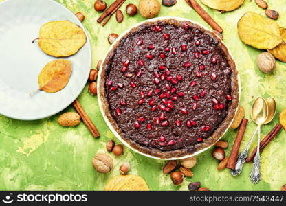 Delicious chocolate cake with pomegranate and nut.Chocolate brownie cake. Chocolate cake with pomegranate