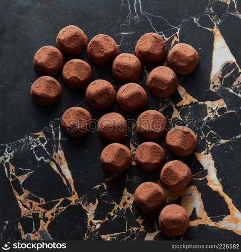 delicious chocolate truffles on a dark marble background. delicious chocolate truffles