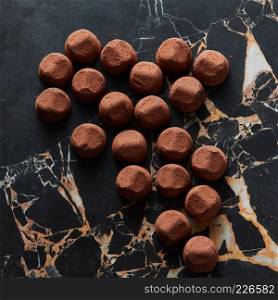 delicious chocolate truffles on a dark marble background. delicious chocolate truffles