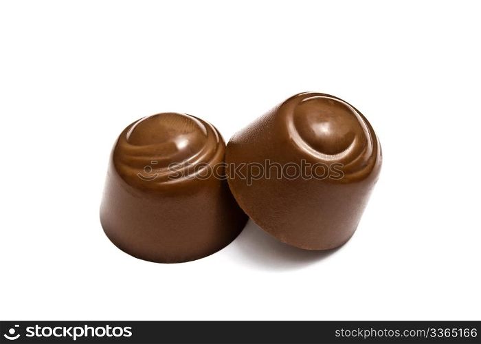 Delicious chocolates closeup on white background