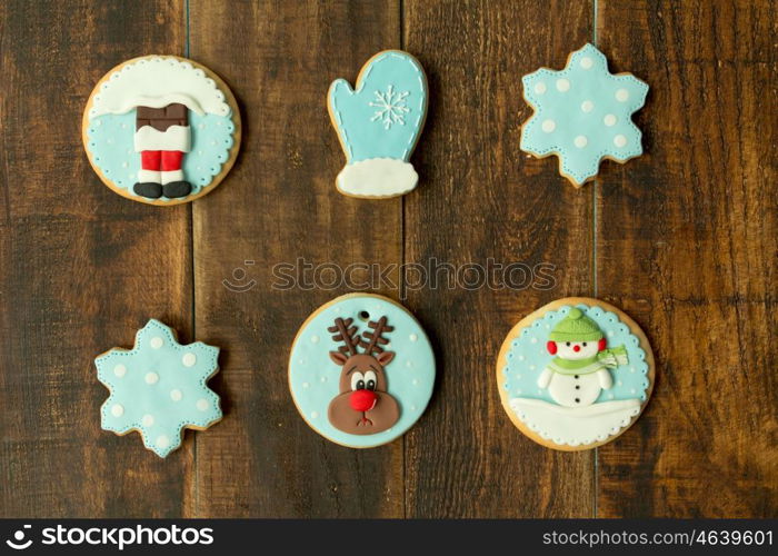 Delicious Christmas cookies in blue tone on a wooden table