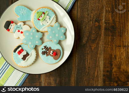 Delicious Christmas cookies in blue tone on a wooden table